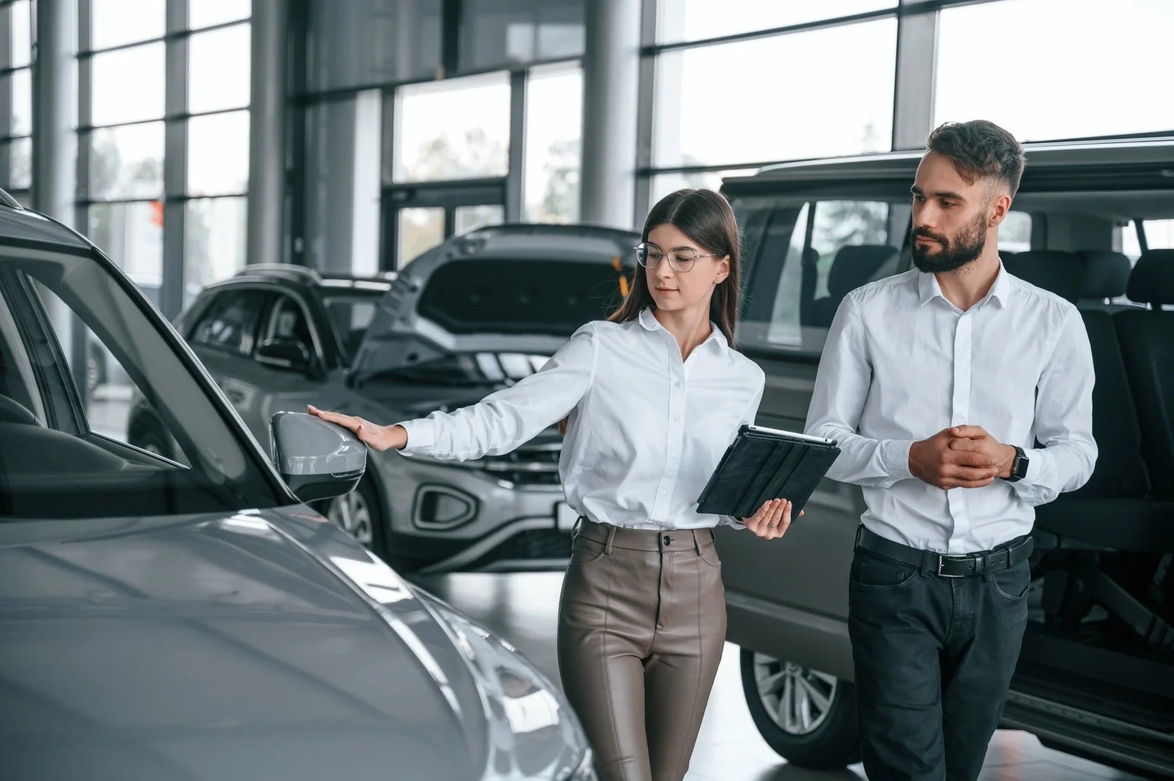 a man inspecting car in showroom